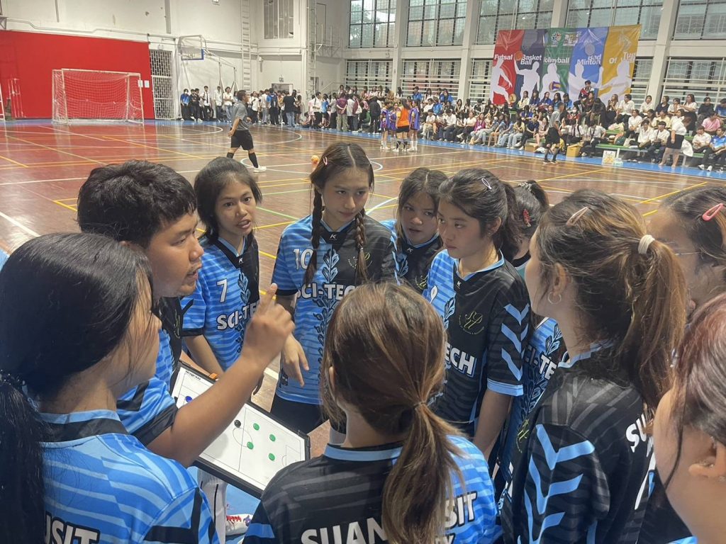 A group of people in a sports hall AI-generated content may be incorrect.