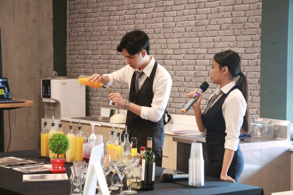 A person and person pouring orange juice into microphones AI-generated content may be incorrect.