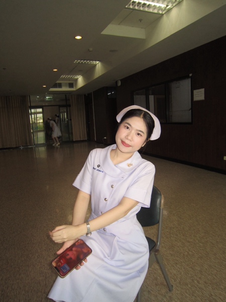 A person in a nurse uniform Description automatically generated