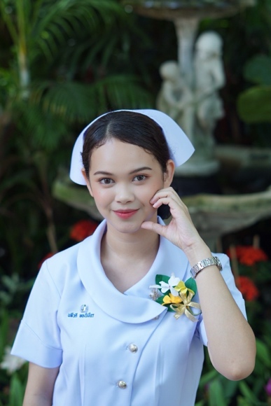 A person in a nurse uniform Description automatically generated