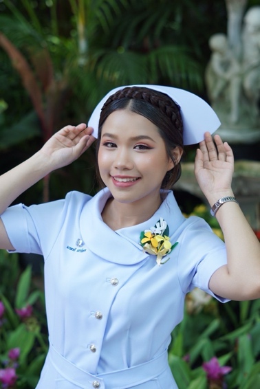 A person in a nurse uniform Description automatically generated