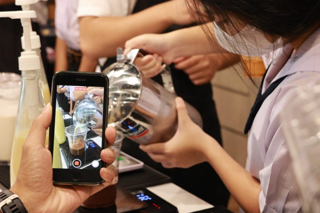 A person taking a picture of a glass jar AI-generated content may be incorrect.